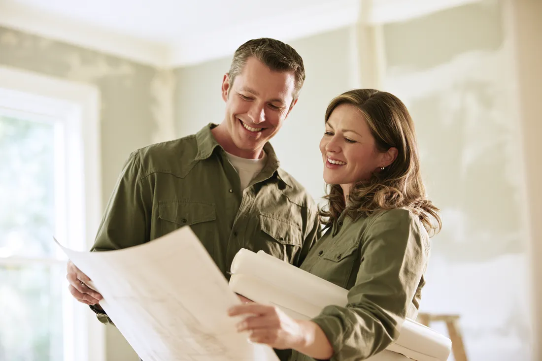 Couple reviewing finished renovation plans funded by a larger personal loan